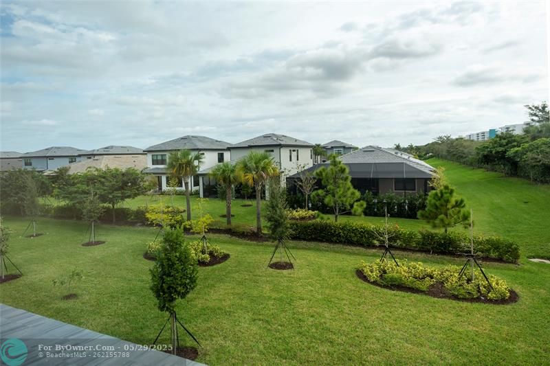 View from Primary Bedroom to large back yard with room for pool.