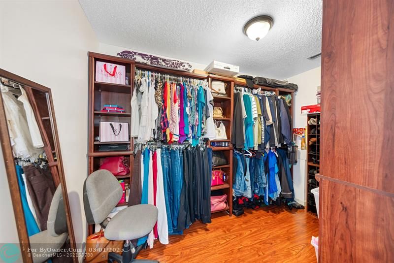Primary bedroom walk-in closet