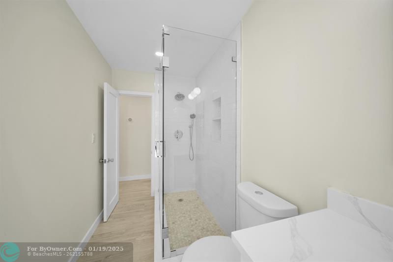 Family bath with custom glass enclosure.