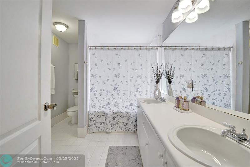 Master bathroom with roman tub & shower, and separate toilet area.