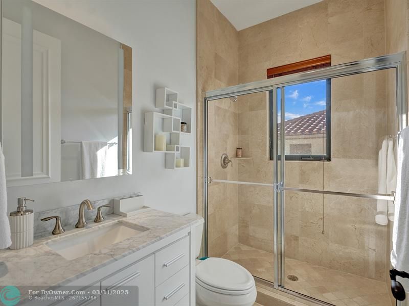 Touches of sophistication: tiles reaching the ceiling in the shower, with a sleek window for refreshing views.