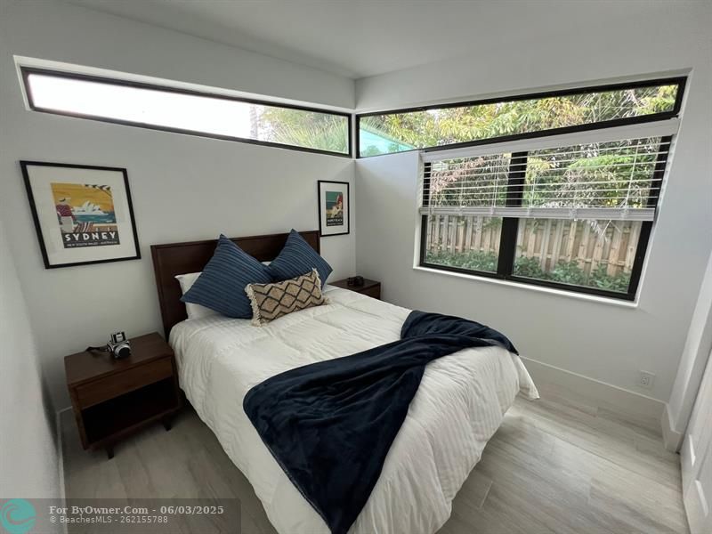 Guest Bedroom with private back yard view, Fantastic Transom windows add style and natural light, ALL Bedrooms are en-suite w/ Full Baths
