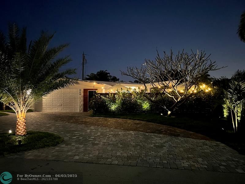 Dramatic Tropical Curb Appeal hints at the beautiful home inside the Courtyard Entrance
