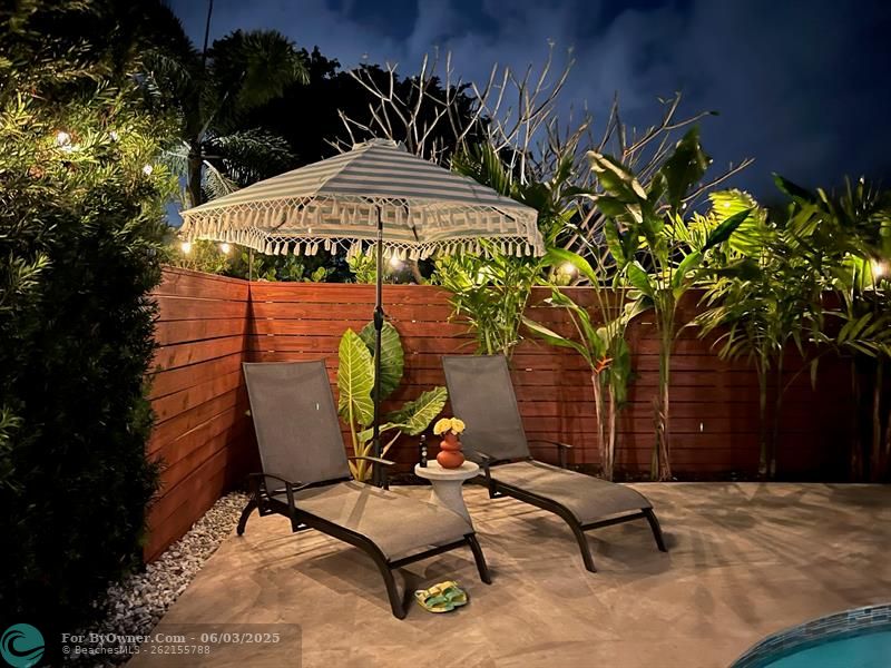 Cozy COurtyard Seating area with Sparkling Pool View