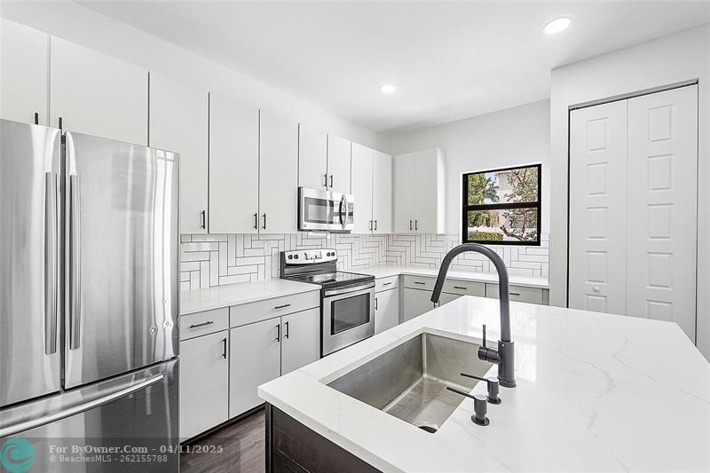 updated kitchen with quartz counters and modern finishes