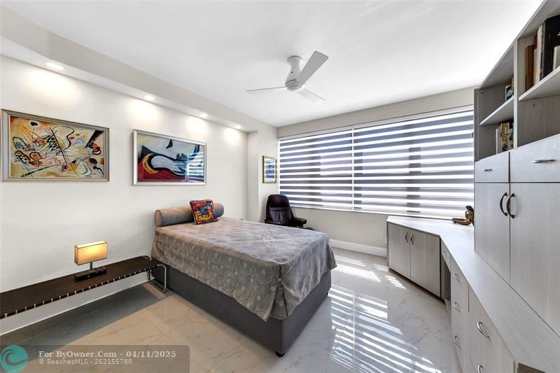 The 2nd Bedroom is equipped with Zebra shades, a multi-functional built-in cabinetry - Dressers, sortage, desk, TV attached to wall remains in unit