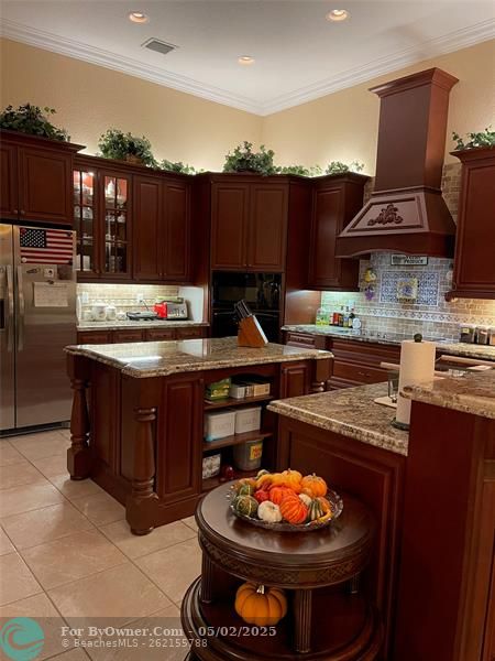 Kitchen has a bar.