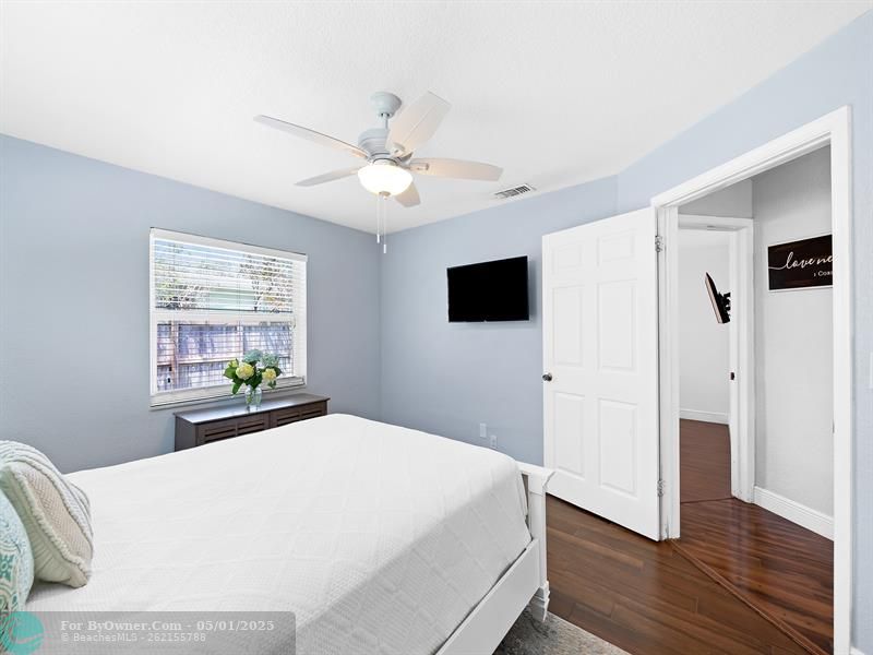 Beautifully finished second bedroom with generous closet space and serene ambiance