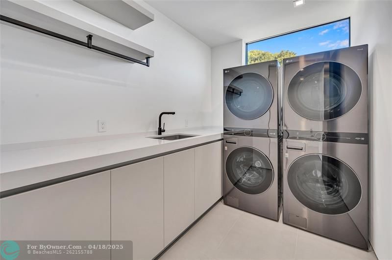 Custom Laundry with Pedini Italian Cabinetry, Blanco Sink, and Double Washer and Dryer setup