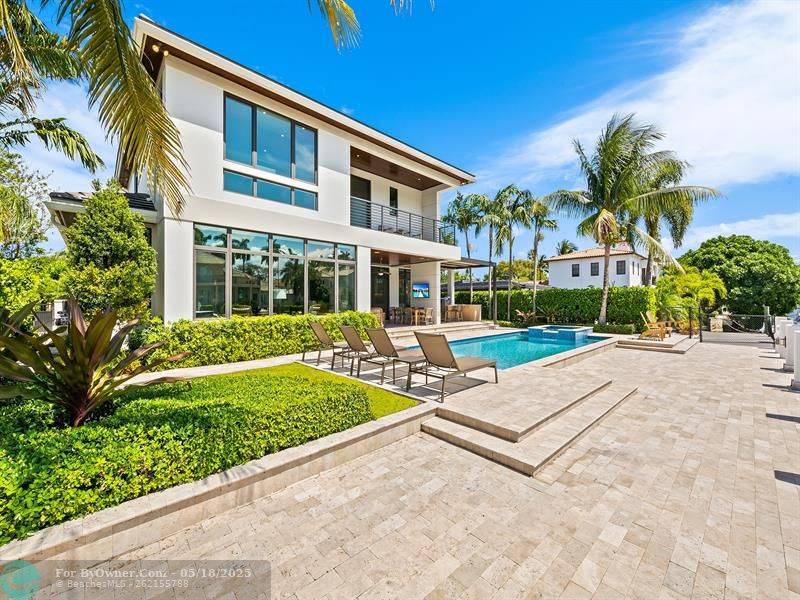 A backyard oasis complete with a sparkling pool/spa and a stylish summer kitchen