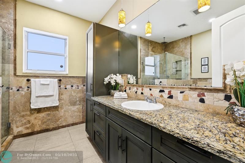 First-Floor Guest Bathroom – the only full bathroom in the home that is not part of an en-suite. Located on the main level for convenience, it features granite countertops, a separate bidet, and easy access for guests. The three additional full bathrooms are private en-suites, each attached to a bedroom for enhanced comfort and privacy.