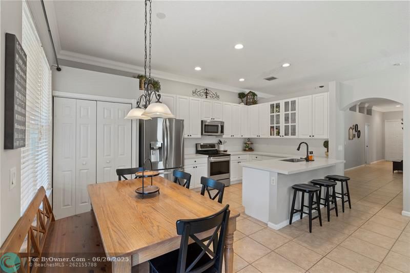 Modern kitchen with quartz countertops, newer stainless appliances opens to a spacious family room perfect for entertaining.