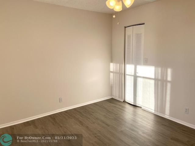 2nd bedroom with new wood floors and walk in closet
