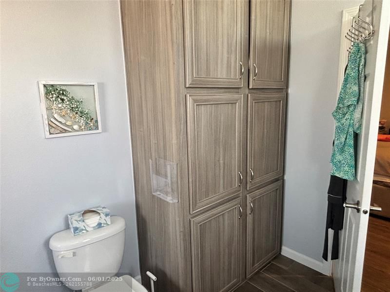 Linen and toiletry storage cabinets