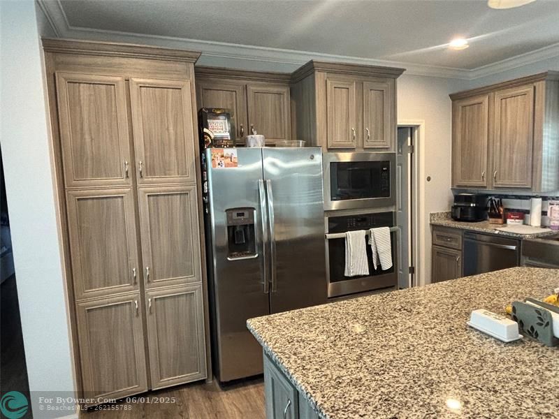 Built in DEEP pantry next to built in refrigerator , microwave and single oven