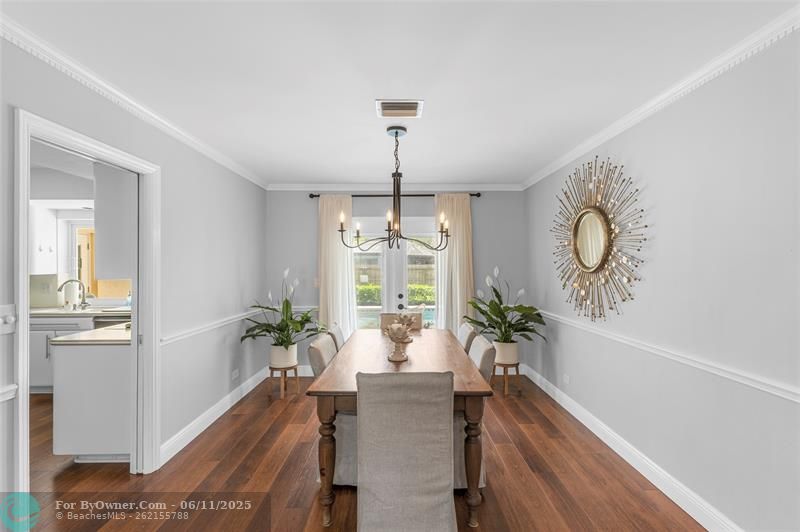 Formal dining room with impact french door to covered patio / pool area / fenced yard