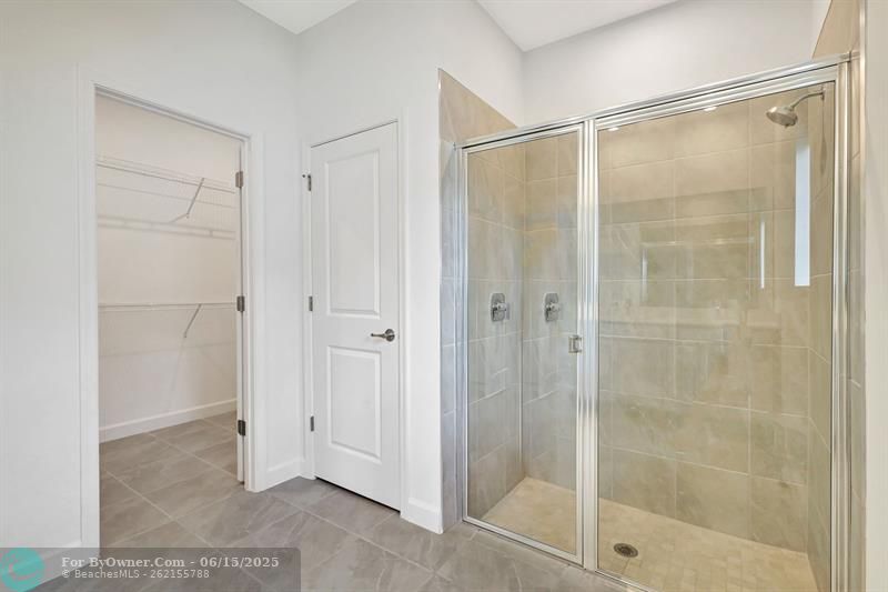 Huge shower, walk in closet and linen closet