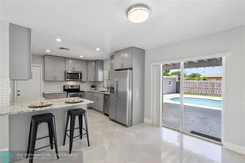 kitchen located off the garage, with pool views