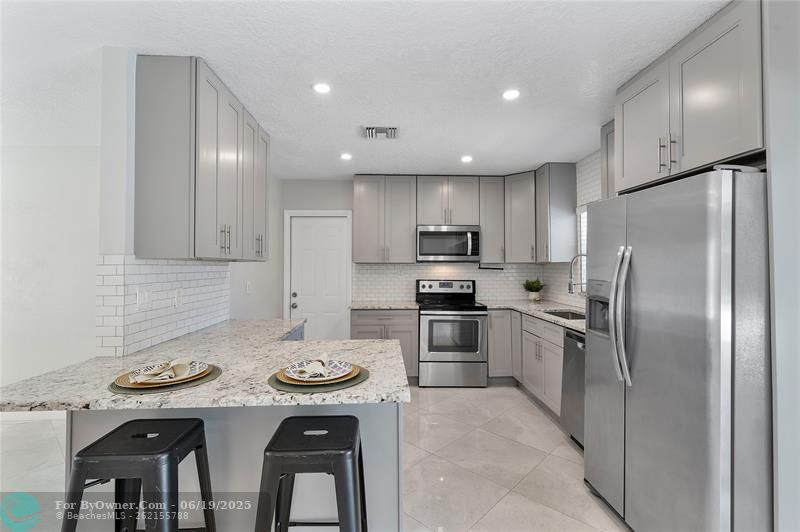 Kitchen with door leading out to laundry room in the garage.