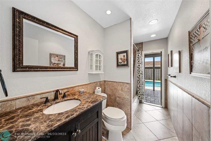 2nd Full Bath 2 with exit to screened porch, pool, & rear yard