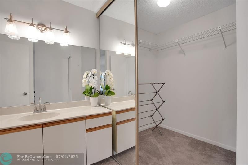 LARGE VANITY IN THE FIRST MASTER BATH AND LARGE WALK-IN CLOSET
