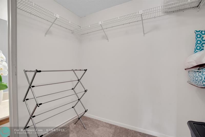 WALK-IN CLOSET IN FIRST MASTER BEDROOM