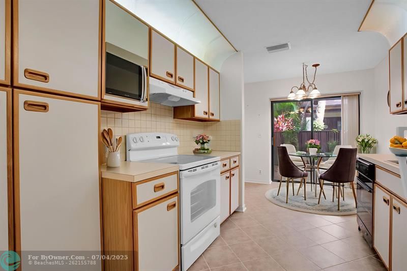 EAT-IN GALLEY KITCHEN WITH SLIDING DOORS TO YOUR PRIVATE FRONT PATIO